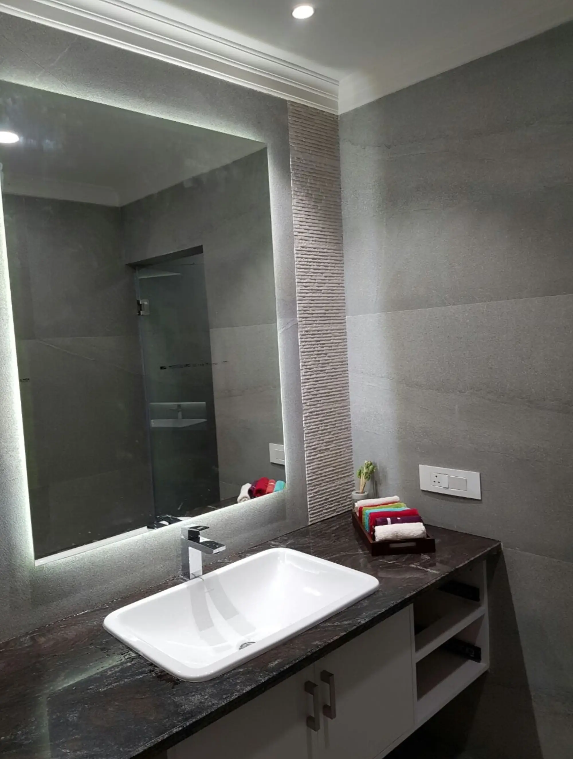 a washbasin and a stunning, large mirror